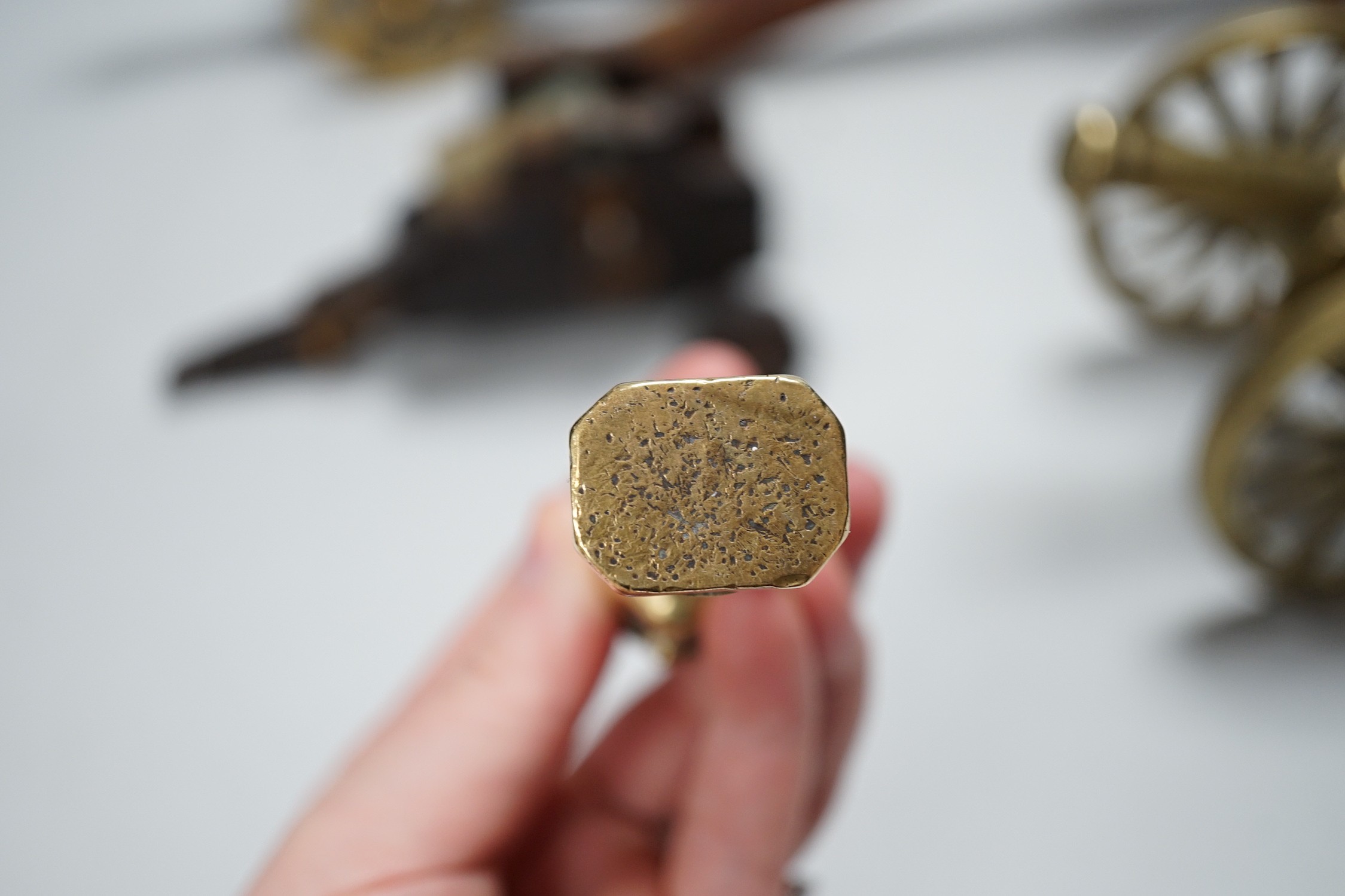 A bronze 'Napoleon bust' desk seal, 8.5cm tall, together with four models of cannons. Largest 39cm wide
